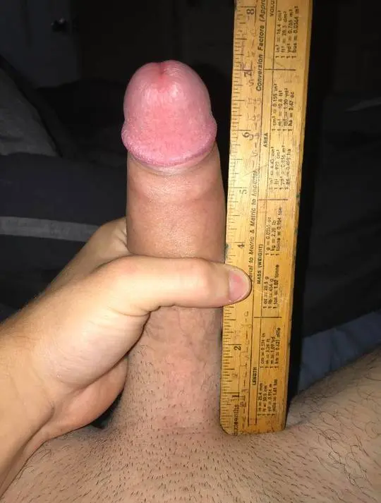 White man with a boner using a measuring tape to show his 7 inch uncut penis and girth.
