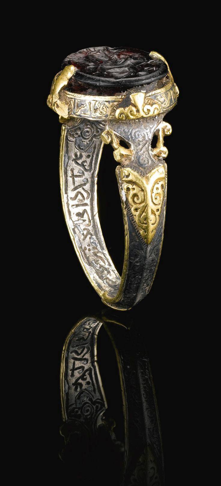 A fine and rare Seljuk silver and gold signet ring set with a purple ...
