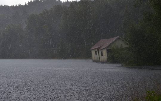 Abandoned Building on a Lake During Rain