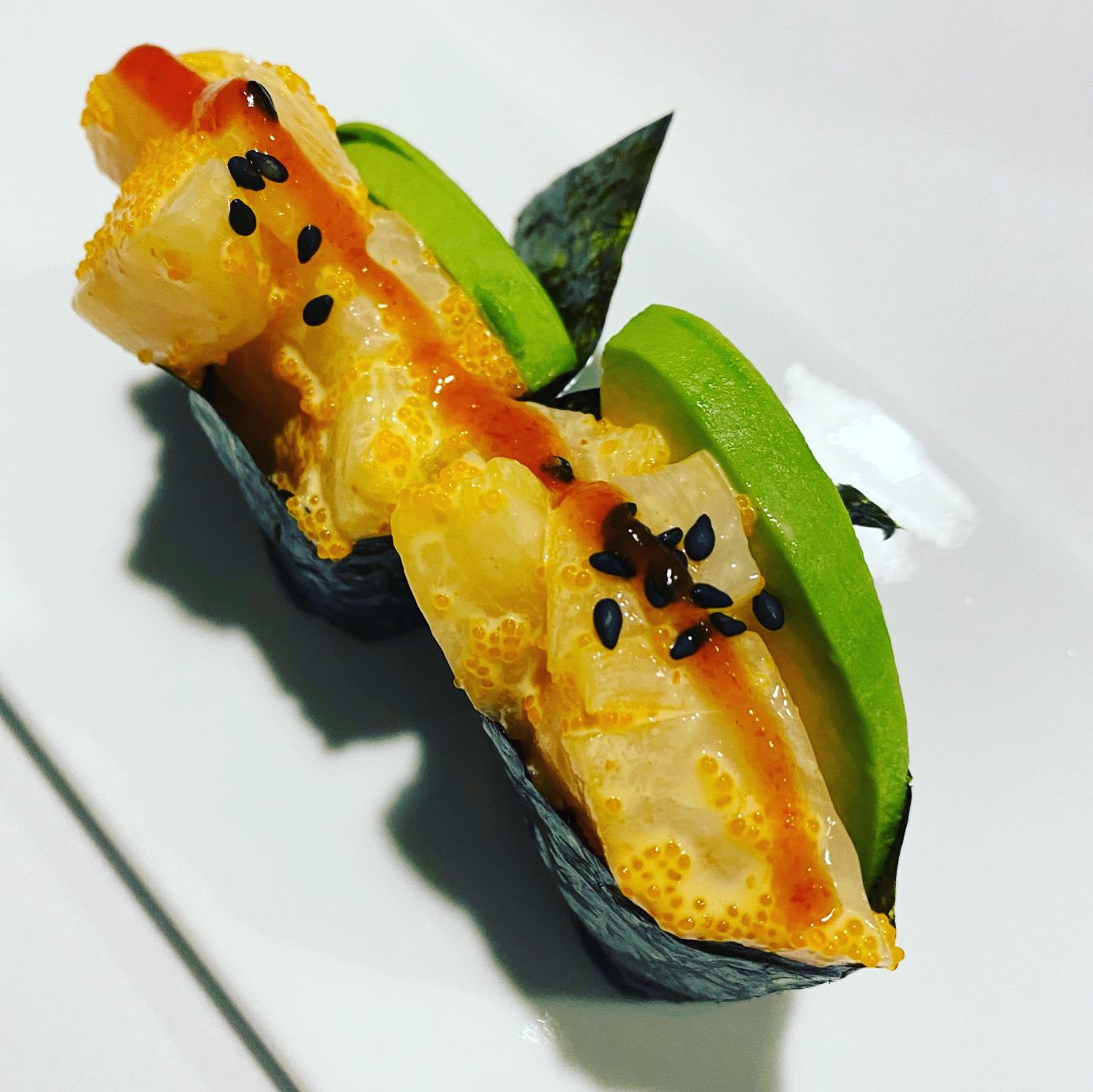 Buttery one-biter. Spicy chopped scallop, masago, avocado, sesame seed ...