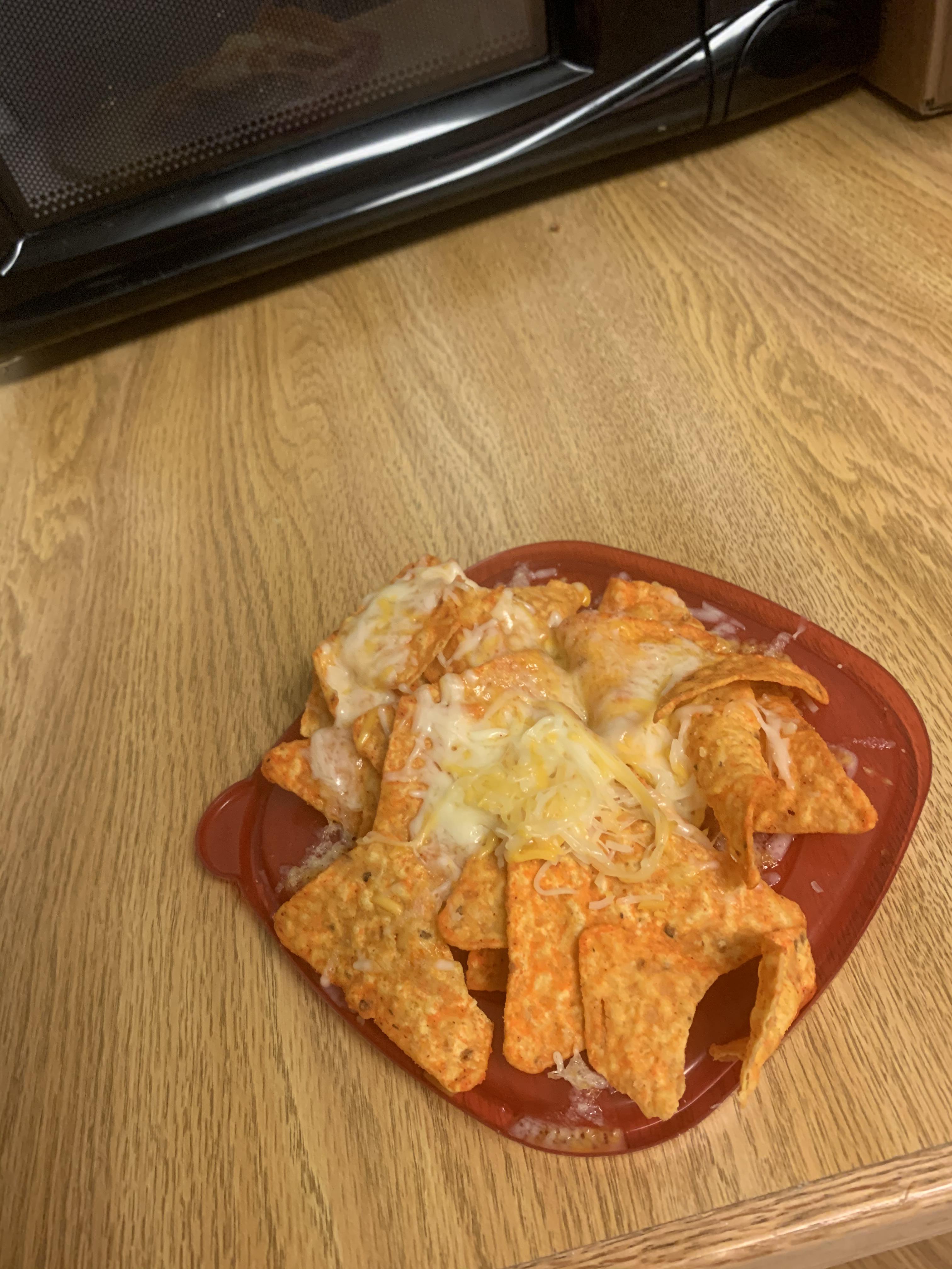 Doritos and kraft shredded cheese microwave and served on a Tupperware