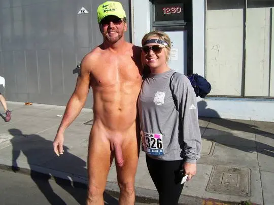 Hung white man posing nude with women in costumes at Bay to Breakers street fair, CFNM public exhibitionism