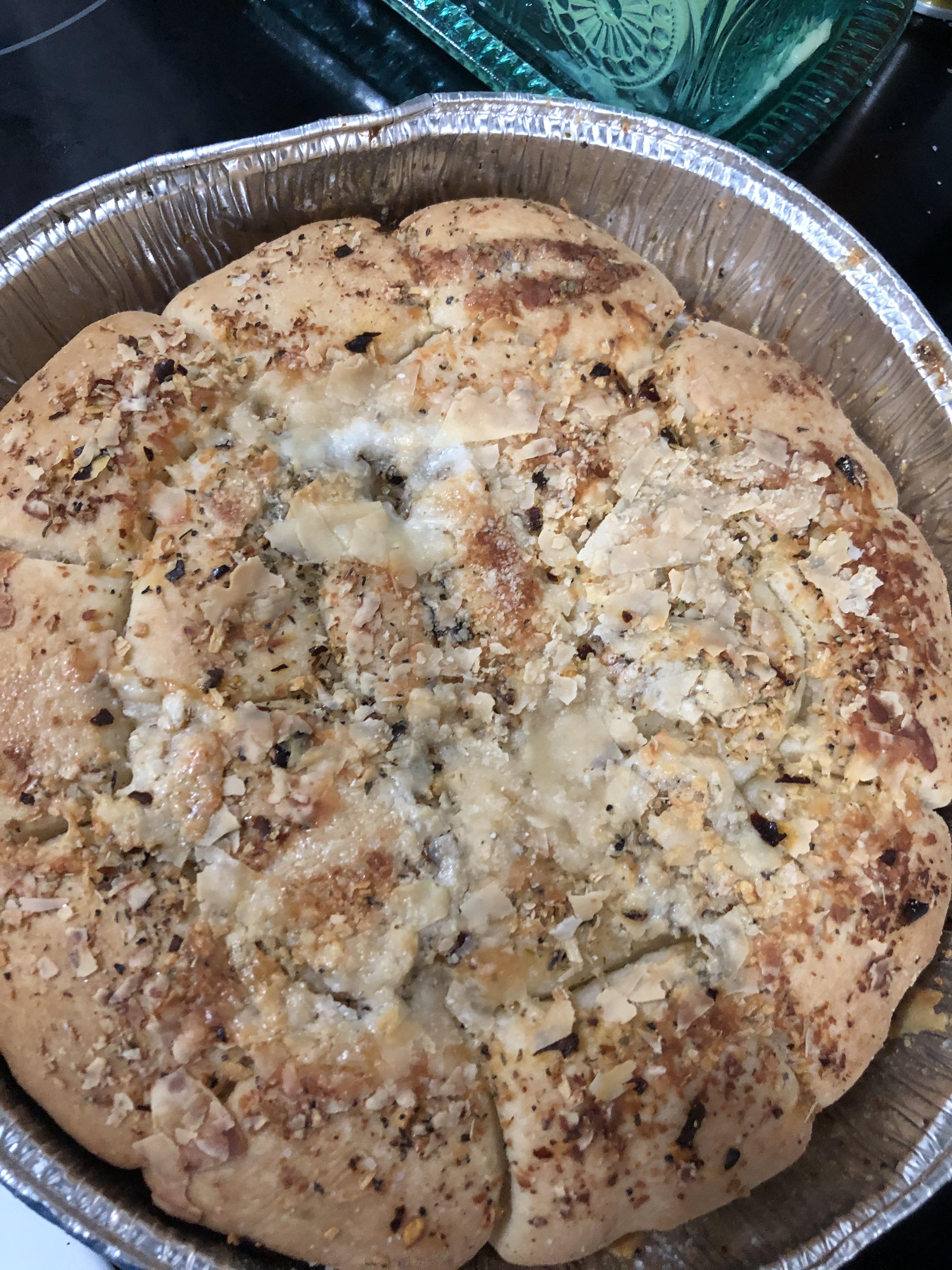 Frozen dinner rolls topped with dried garlic, dried onion, butter