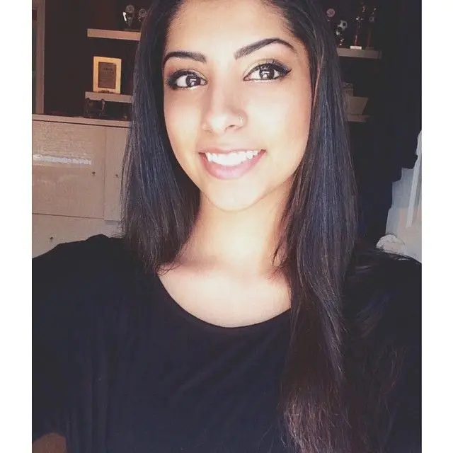Mixed race desi girl with a nose ring posing for selfies, both clothed in a black t-shirt and naked.