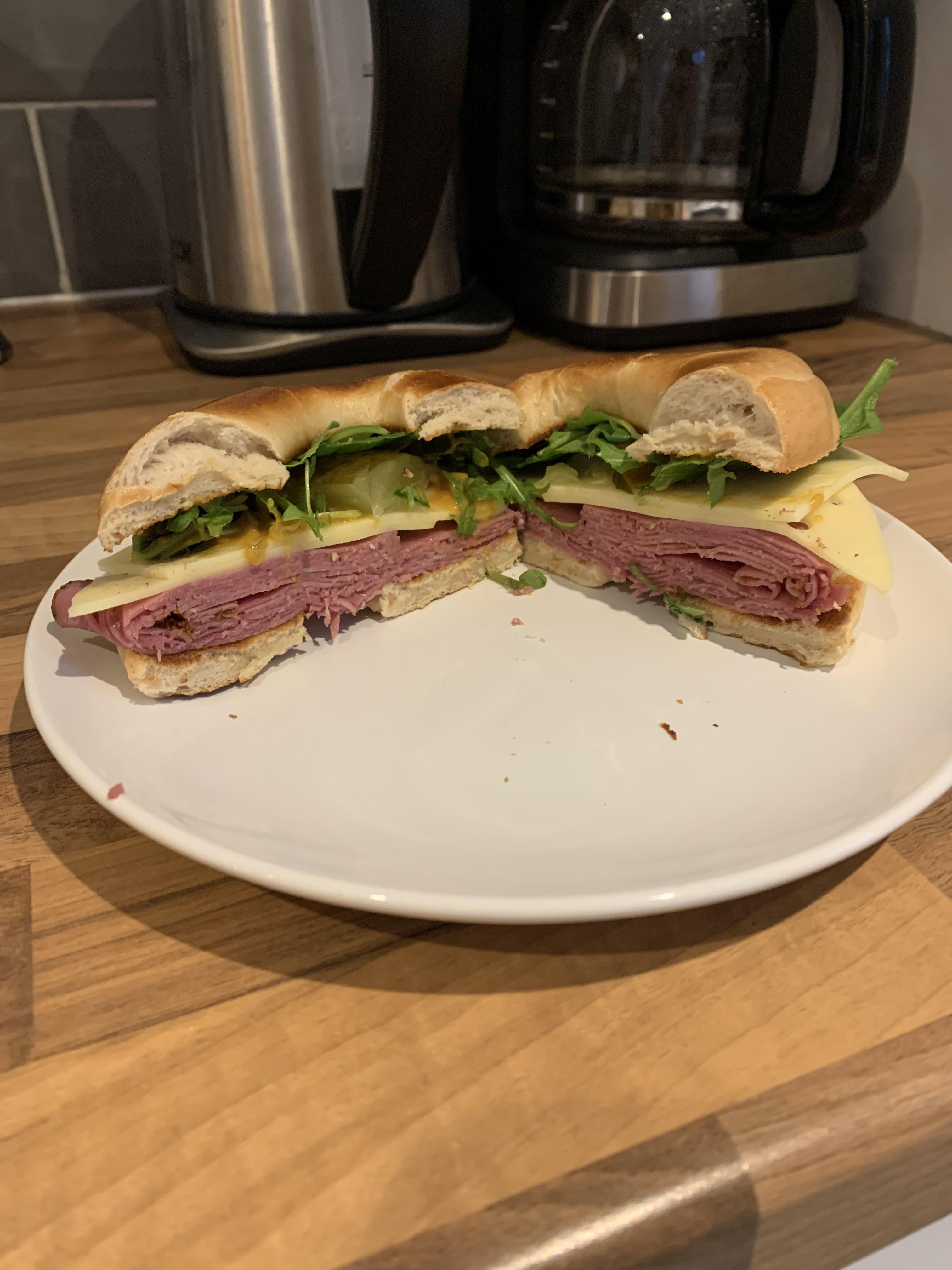 Pastrami, Jarlsberg, pickle, rocket, spinach, and mustard relish on