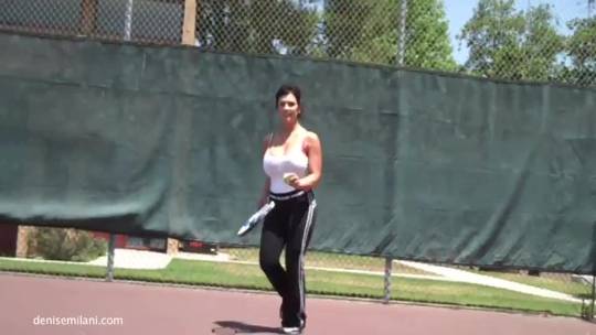 Playing tennis.