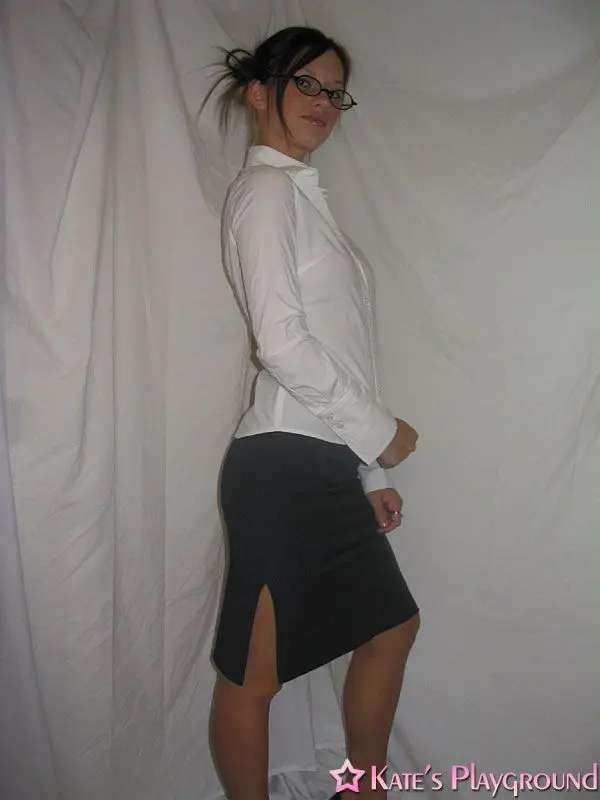Kate in a sexy teacher outfit featuring a white blouse, tight grey pencil skirt, and glasses