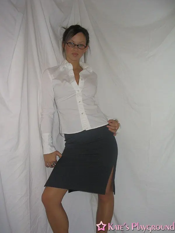 Kate in a sexy teacher outfit featuring a white blouse, tight grey pencil skirt, and glasses