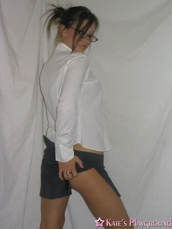 Kate in a sexy teacher outfit featuring a white blouse, tight grey pencil skirt, and glasses