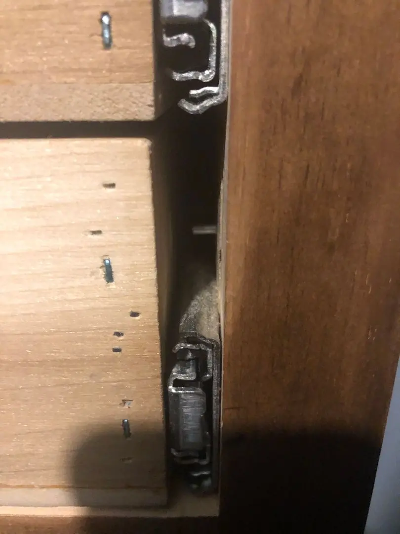 Sex toys including dildos, vibrators, and anal beads organized in a wooden dresser drawer