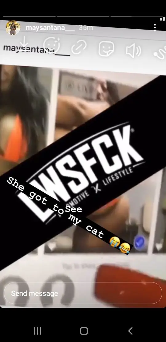 Maysantana in an orange garment on a social media story with text overlay and a blurred indoor background.