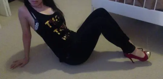 Curvy Persian woman in a black tank top and leggings stripping to reveal polka dot lingerie and 32DDD breasts