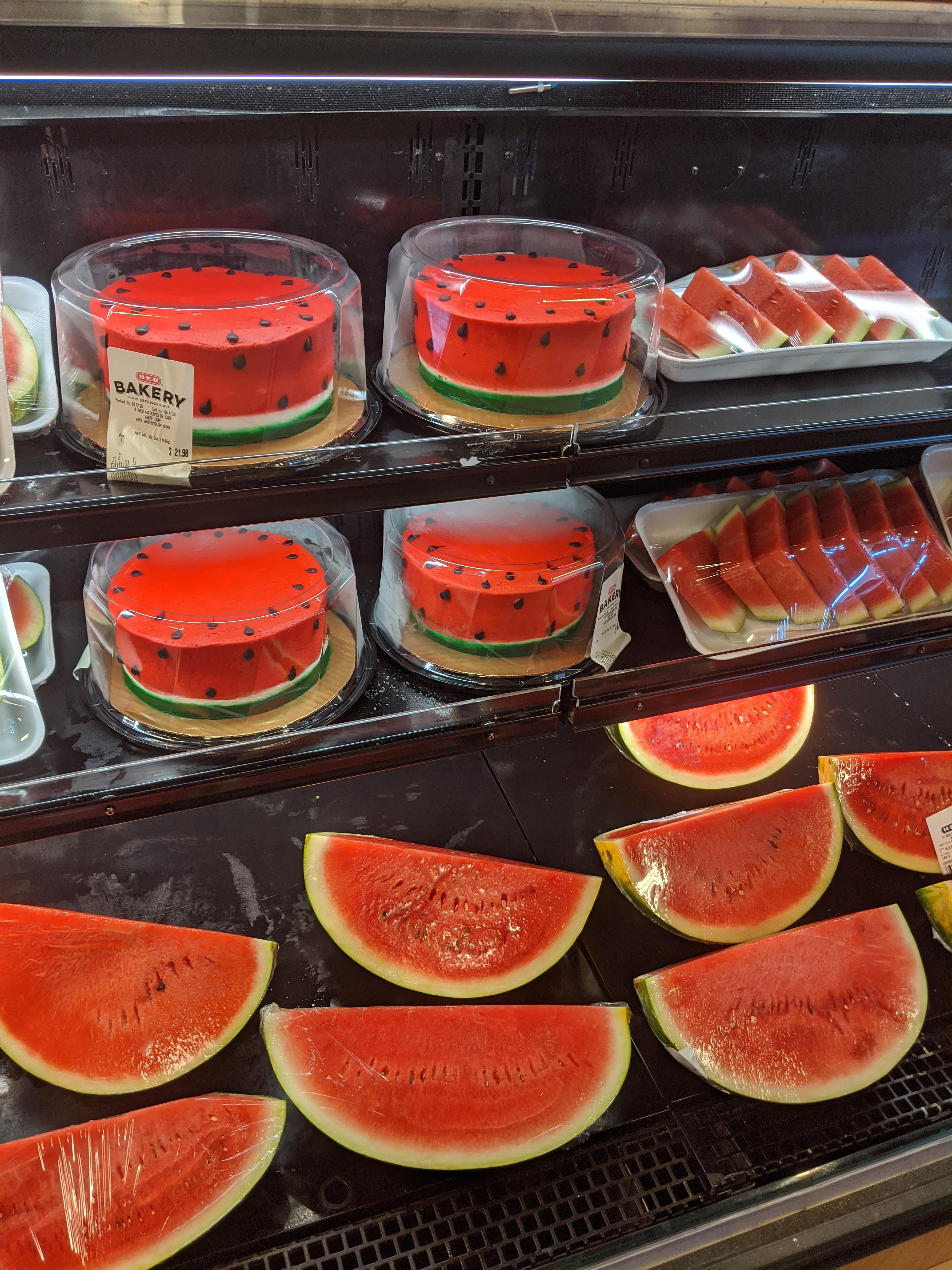 This grocery display contains both watermelon and watermelon cakes ...