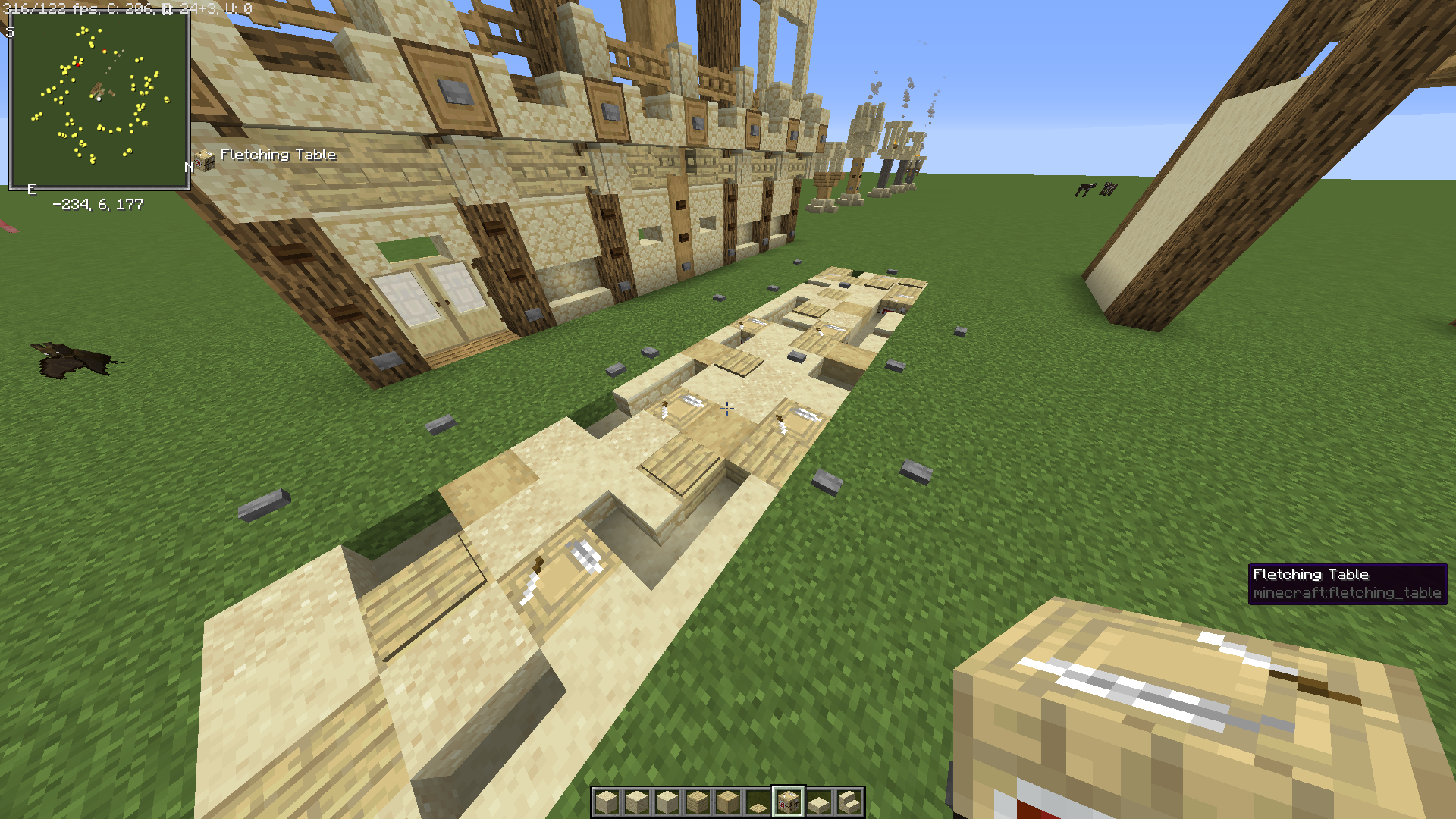 You can use fletching tables in sandy pathways to make it look like