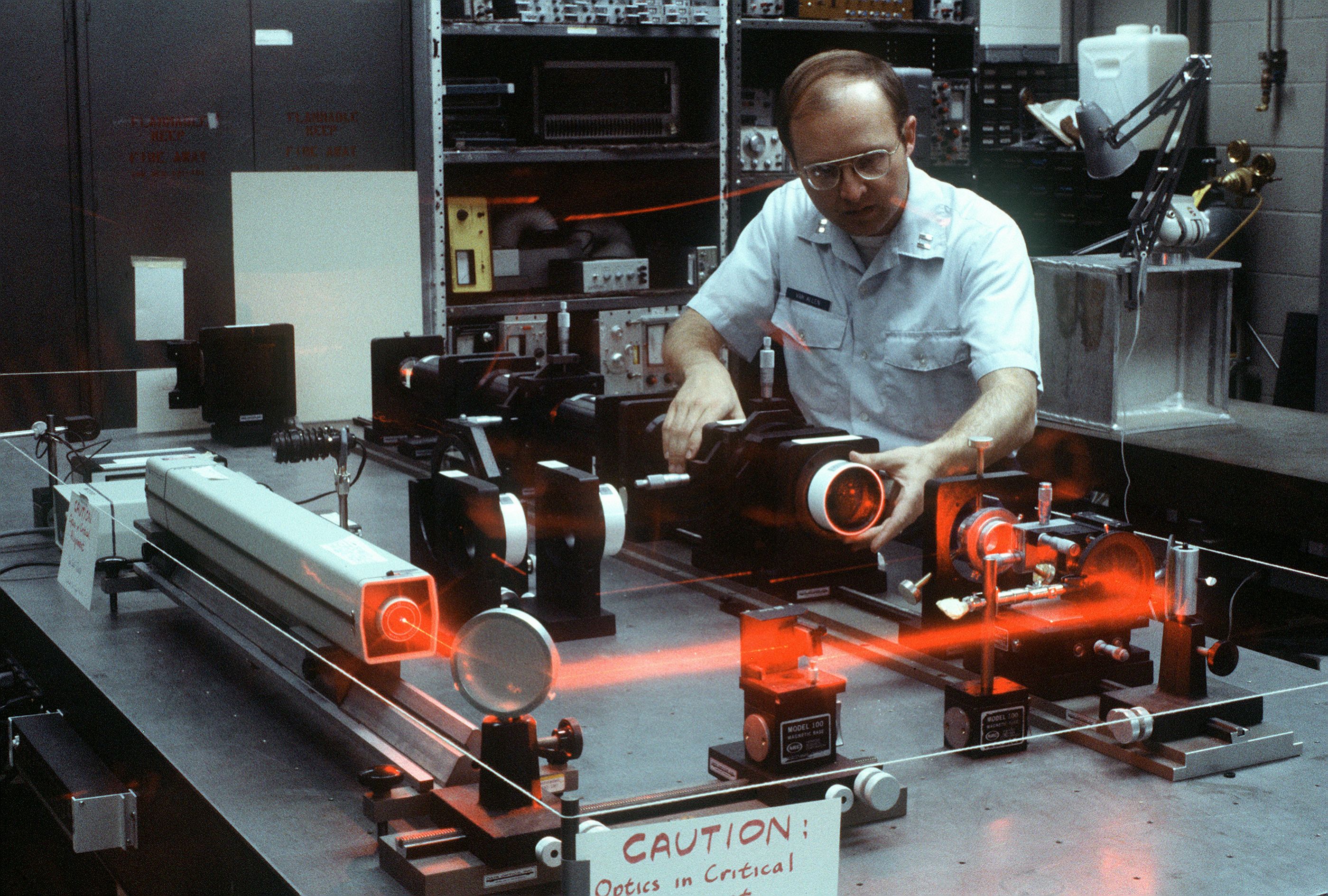 A High Energy Laser Beam Control Engineer adjusts the alignment of an ...