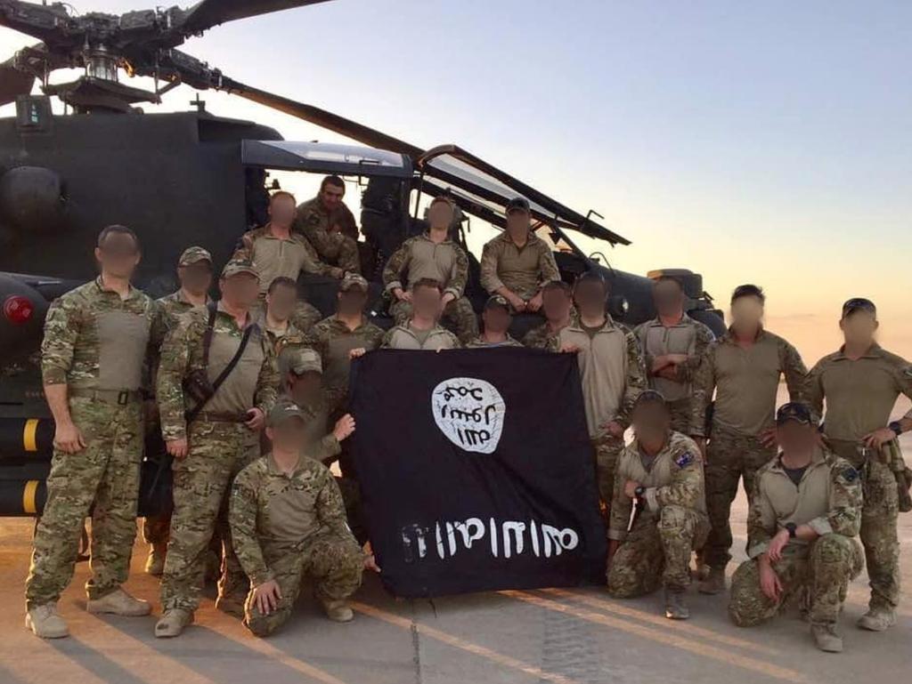 Australian Commandos from the 2nd Commando Regiment hold up a captured ...