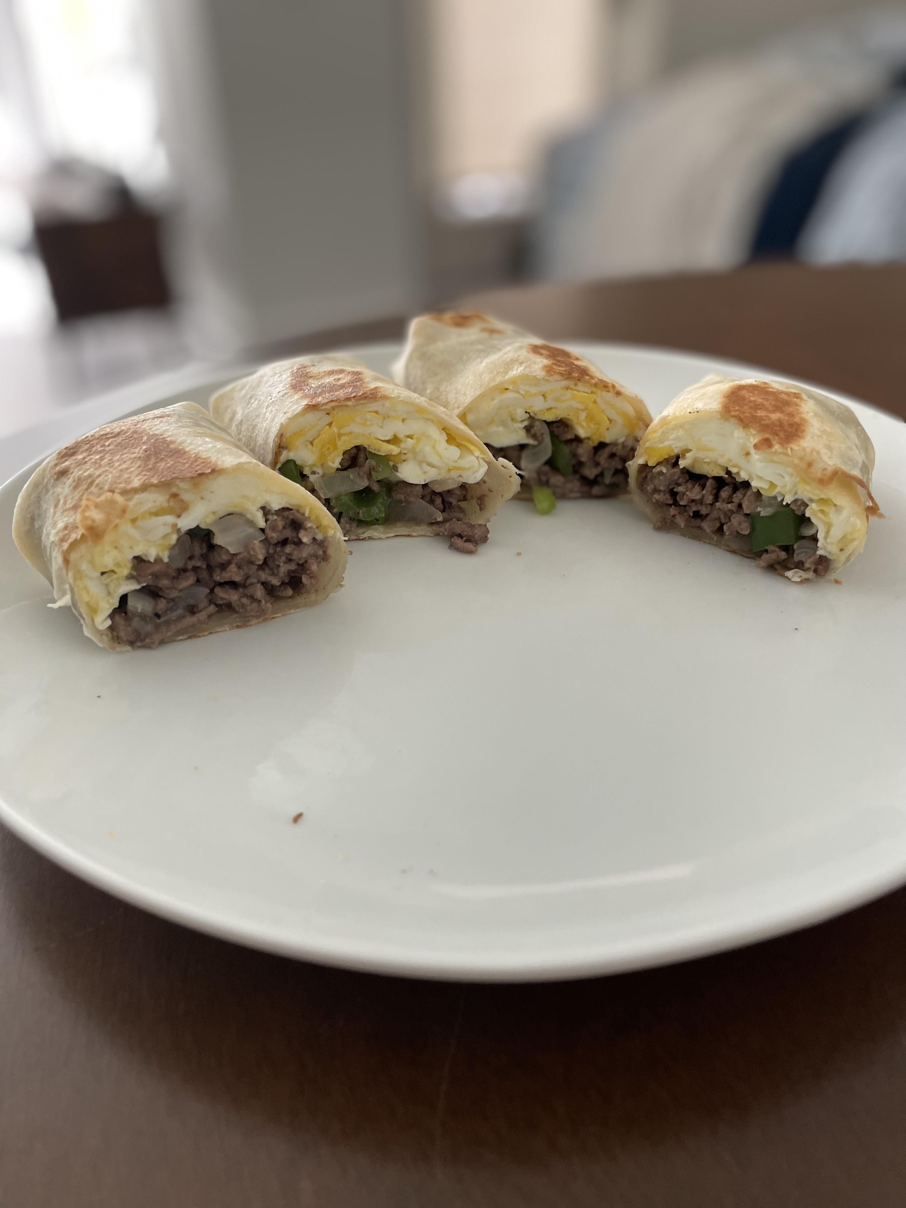 Breakfast burritos with egg, ground beef, sautéed onion, and hatch