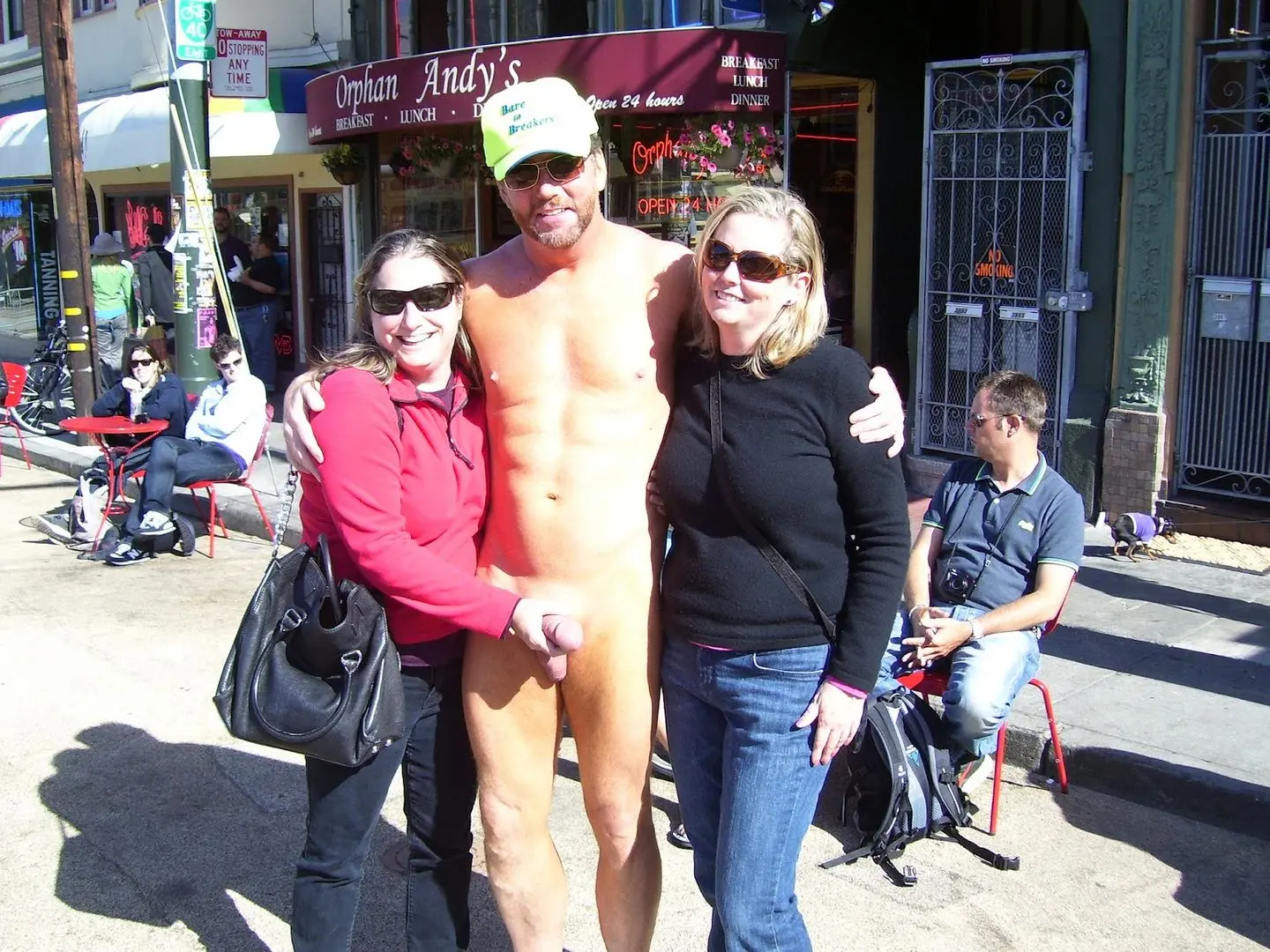 Hung white man posing nude with women in costumes at Bay to Breakers street fair, CFNM public exhibitionism