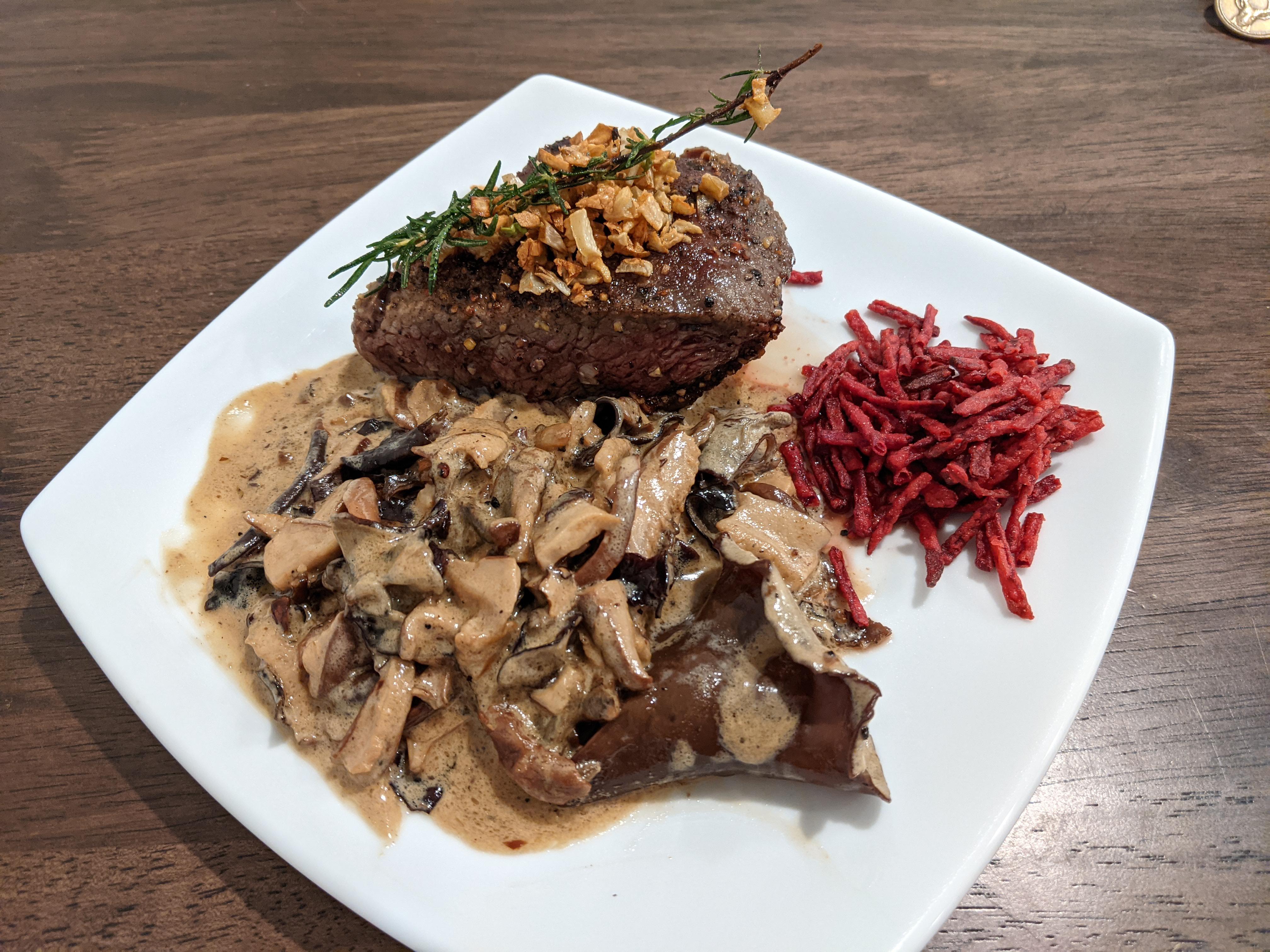 Flat iron steak finished with Truff black truffle oil, mushroom gravy