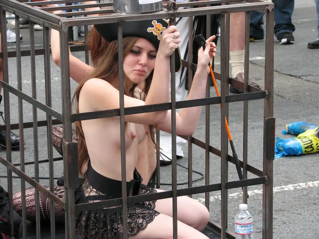 Women in bondage harnesses, leather corsets, and lace lingerie at the Folsom Street Fair.