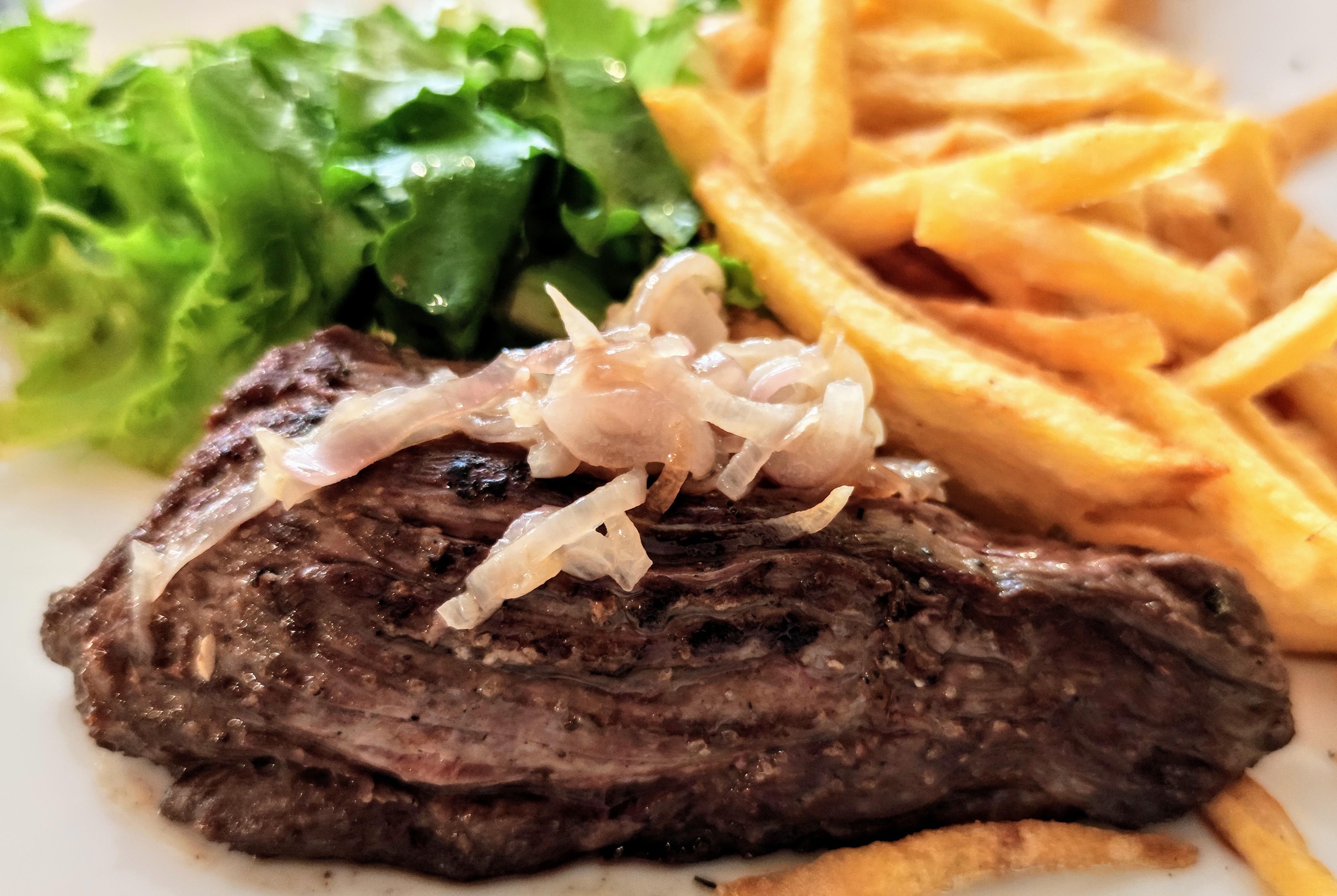 Grilled sirloin steak, french fries and mesclun salad at the restaurant