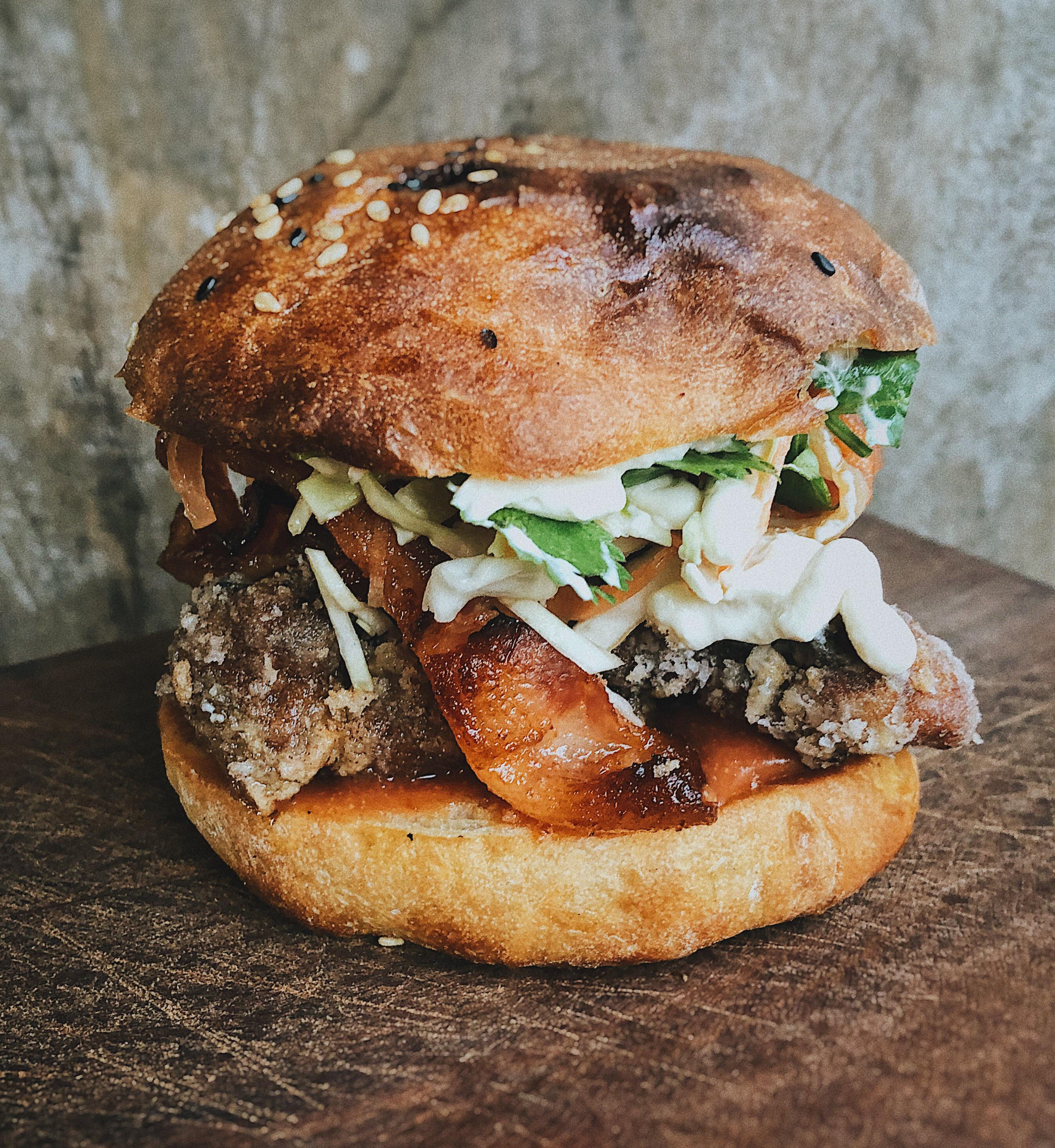 Karaage chicken thigh, miso ketchup, brown sugar sriracha bacon, pickled carrot slaw, bean