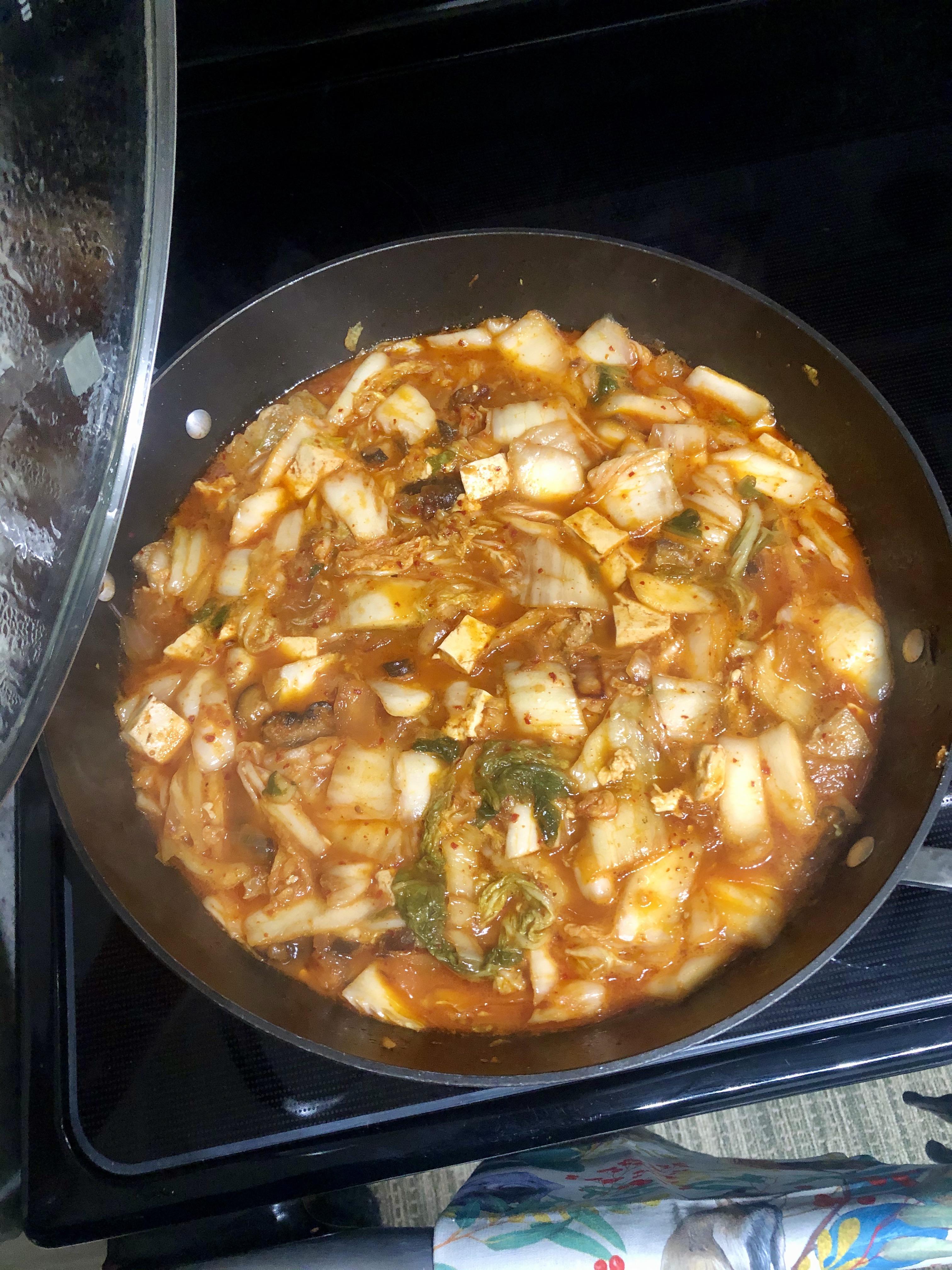 Kimchi jjigae with pork belly, shiitake mushrooms, tofu and a whole lot