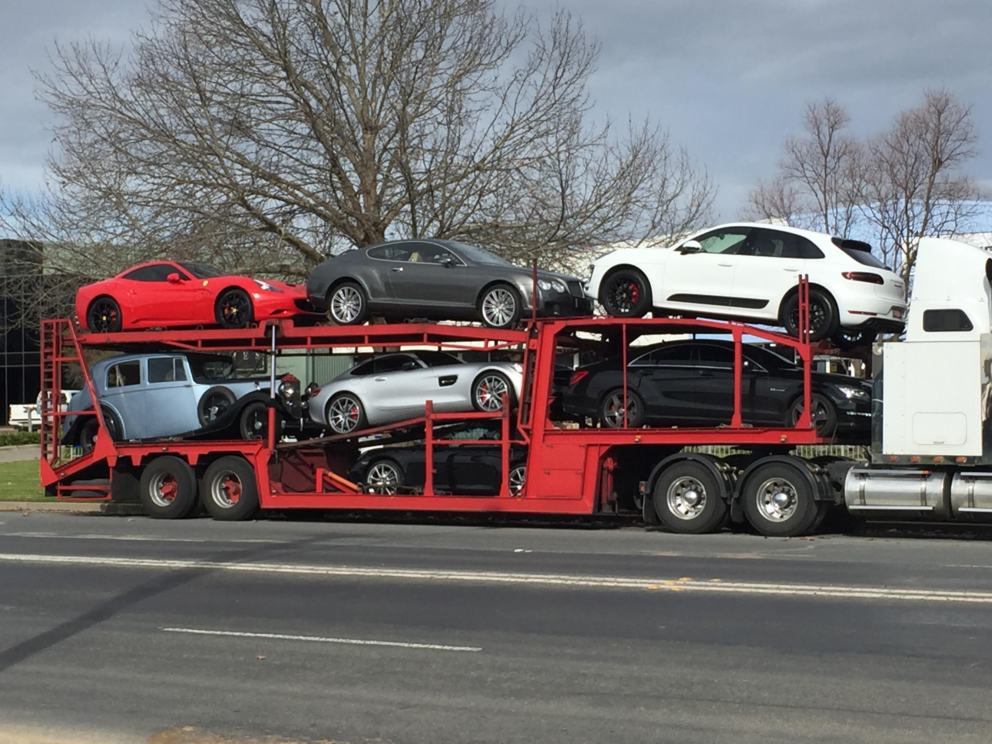 [multi] Various luxury cars on a car carrier; NSW, Australia Scrolller