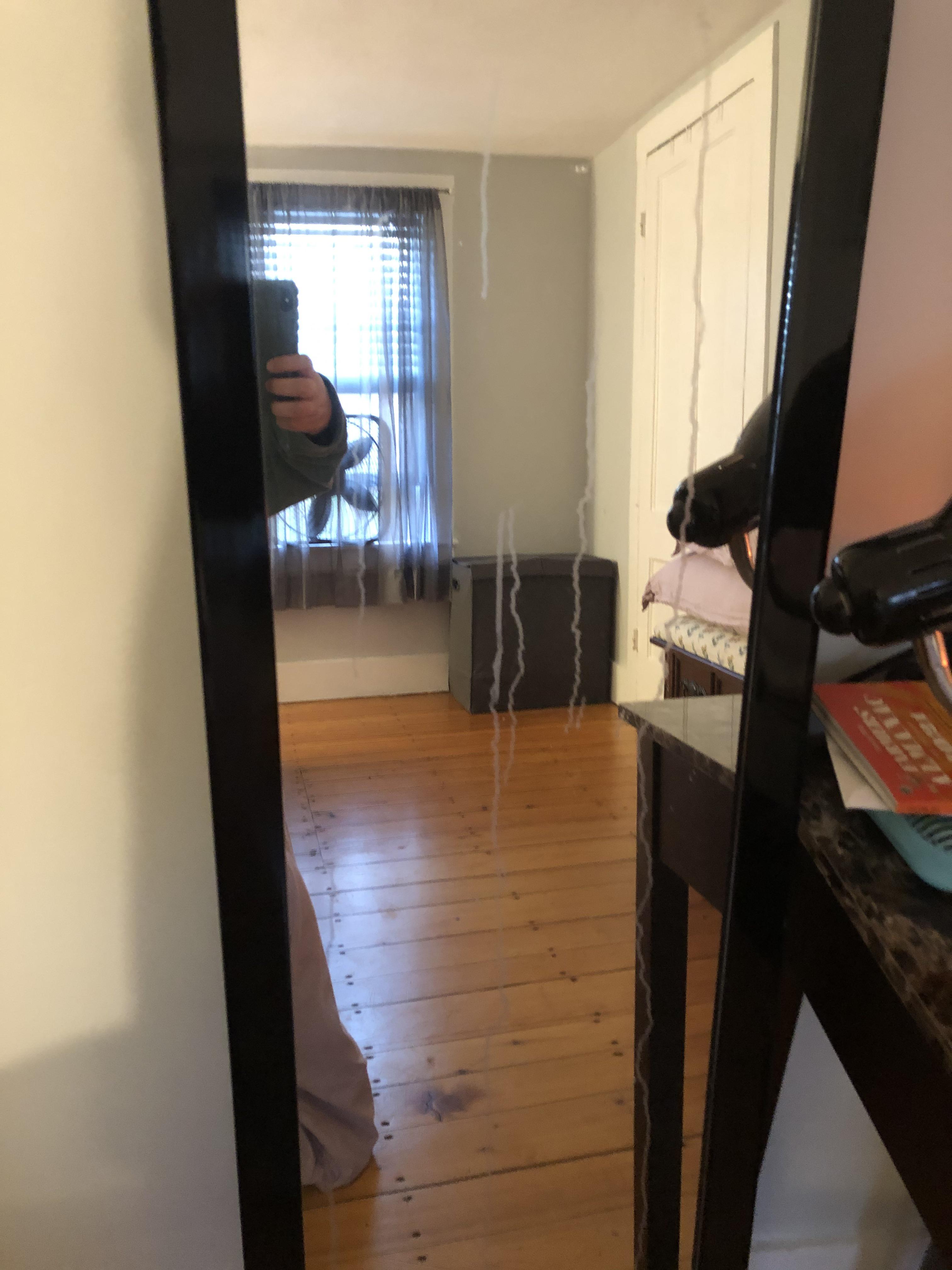 Our bedroom mirror developed these weird white streaks down it today