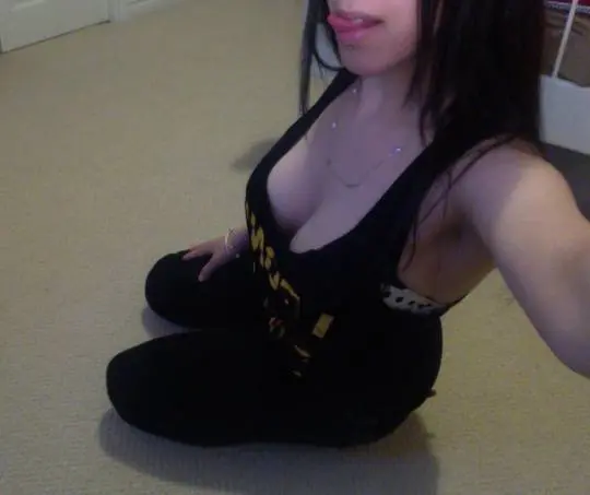 Curvy Persian woman in a black tank top and leggings stripping to reveal polka dot lingerie and 32DDD breasts