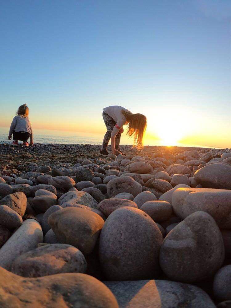 Throwing rocks at the beach while capturing the sun going down Scrolller