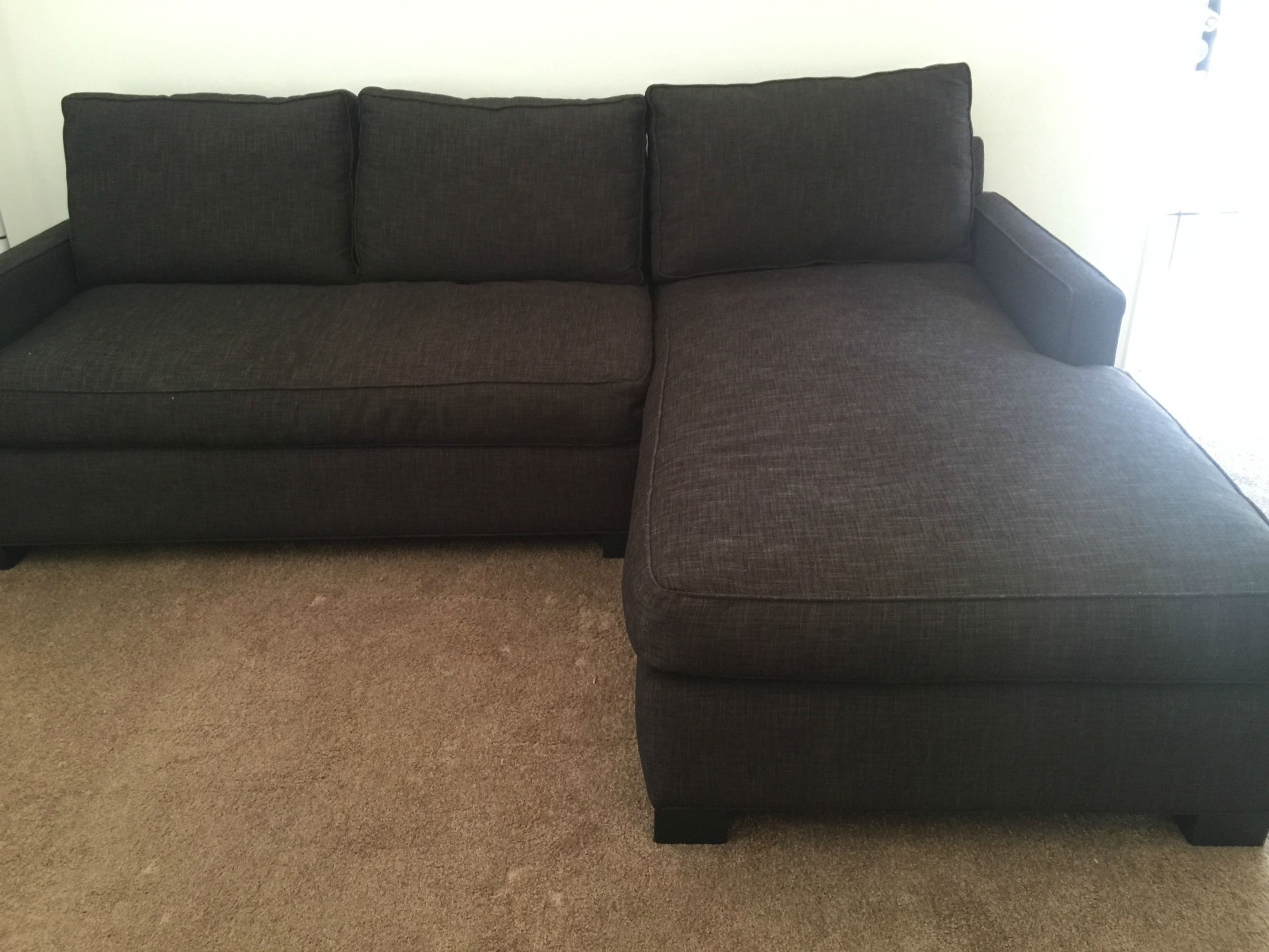 weird brown carpet + dark charcoal/brown couch + white walls. what