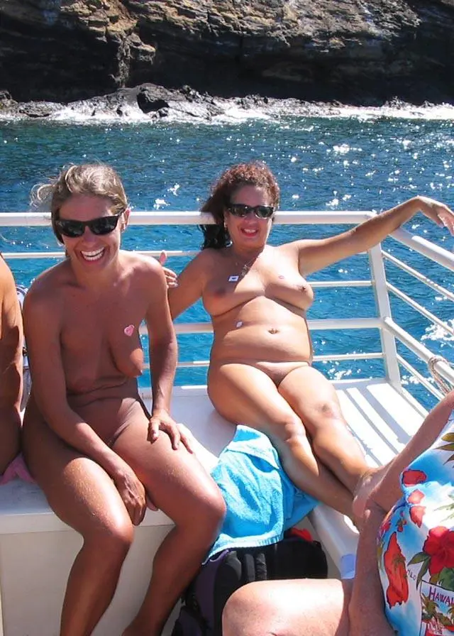 A couple of MILFS relaxing on a nude boat ride