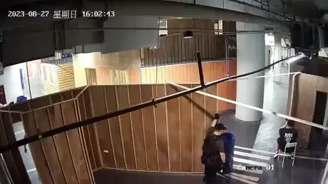Airsoft player performs tactical slide out the corner to take out another player during indoor CQB Airsoft wargame