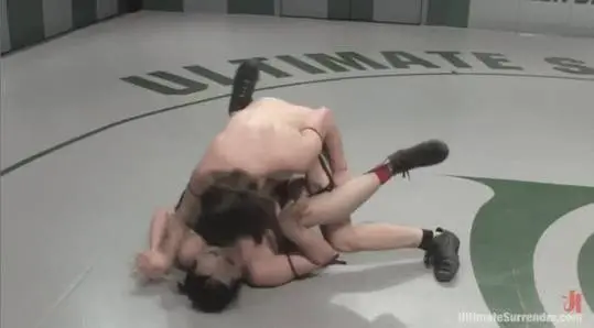 Alexa von Tess and Brix in a girl on girl wrestling match, pinning each other in black lingerie