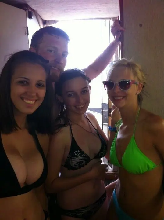 Amanda Ann and a blonde friend in bikinis posing with a monkey in a tropical setting