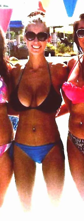 Amanda Ann and a blonde friend in bikinis posing with a monkey in a tropical setting