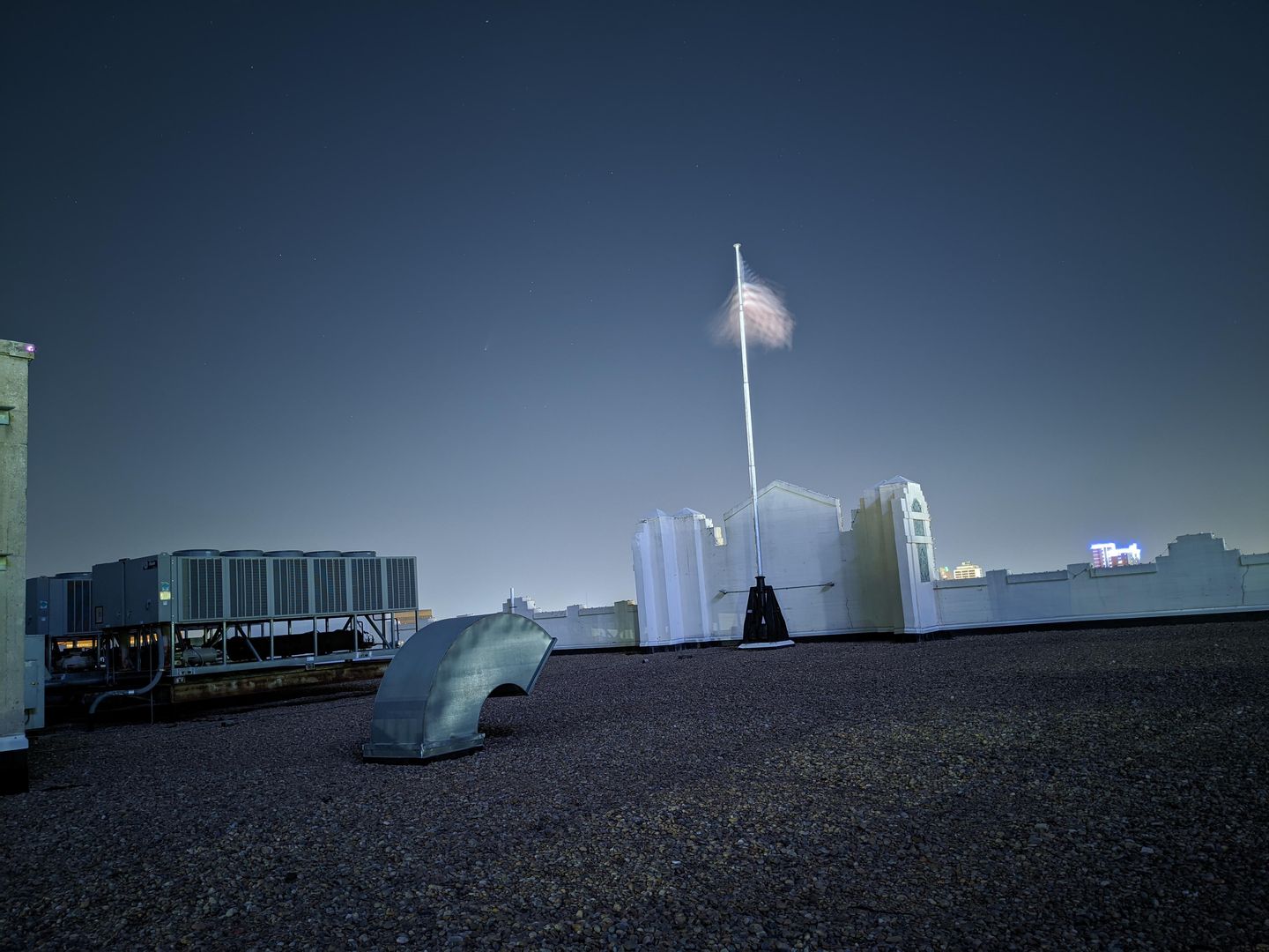 Caught Neowise at the top of The Montgomery. Google Pixel 4XL Astrophotography mode. Comet is to the left of the flag.