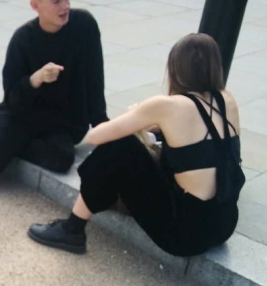 College girl in bra and dungarees