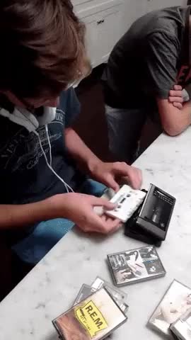 Examining new generation with cassette player