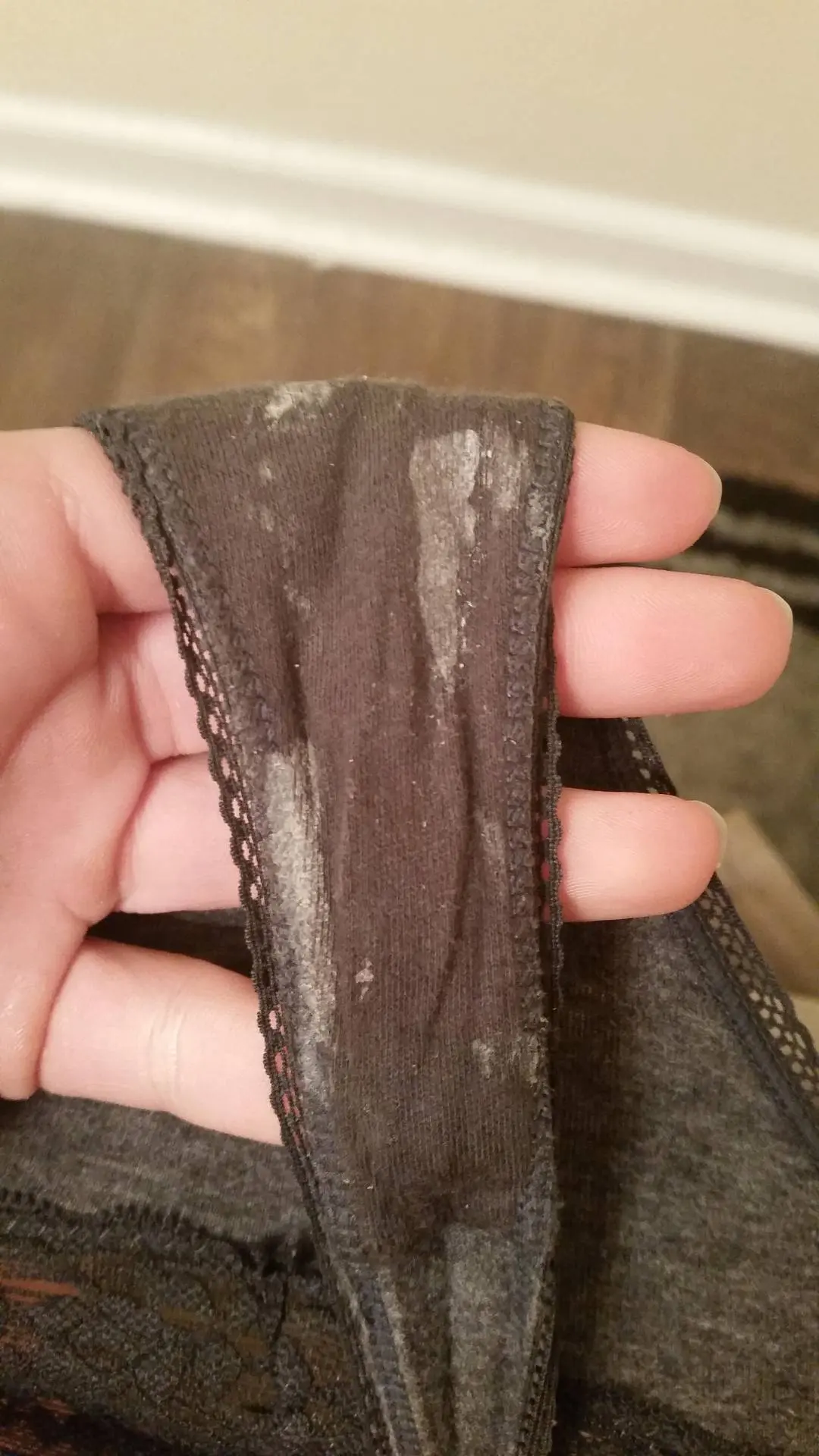 Woman showing dirty panties with wet panty nectar and underwear marks on the gusset