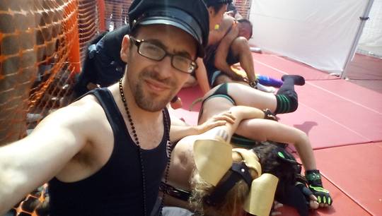 Kato and Pepper in pup play gear and masks at the Folsom Street Fair, including a man in a tiger costume.