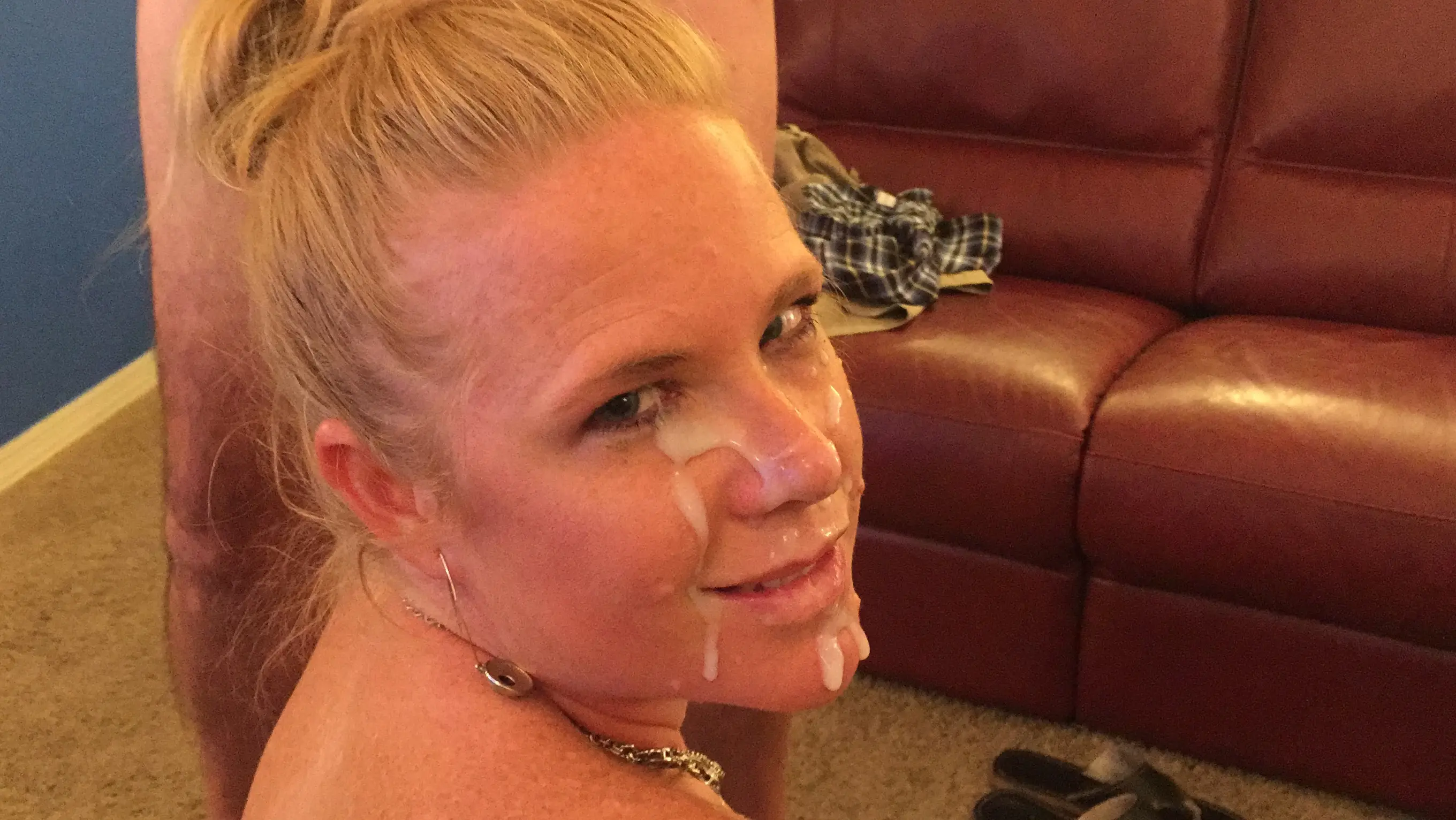 Busty blonde hotwife in lingerie and blue clothing performing a blowjob and posing for cum selfies