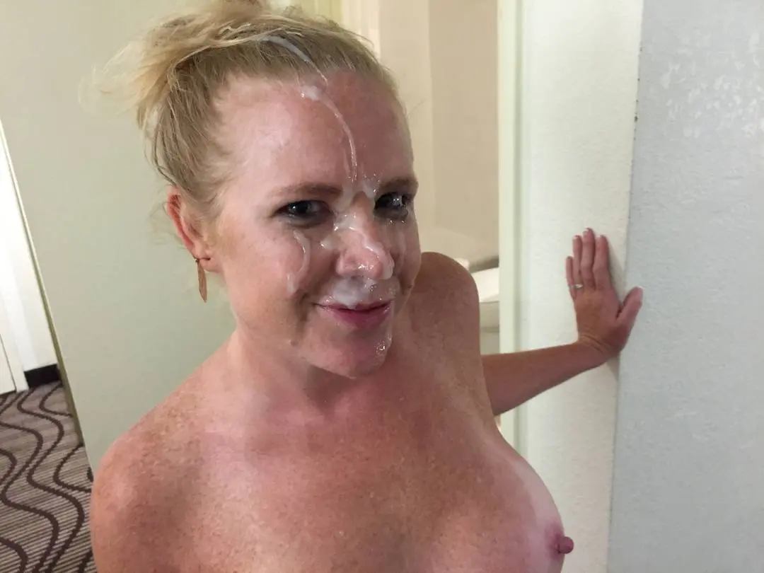 Busty blonde hotwife in lingerie and blue clothing performing a blowjob and posing for cum selfies