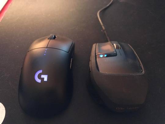 Two black G9x Laser computer mice side-by-side on a dark surface, part of a cool gaming pc setup.