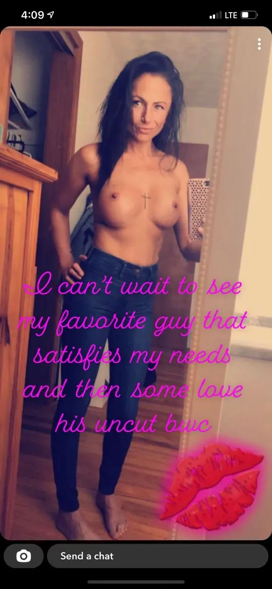 Topless brunette hotwife in blue jeans taking a mirror selfie with a chest tattoo and BWC caption.