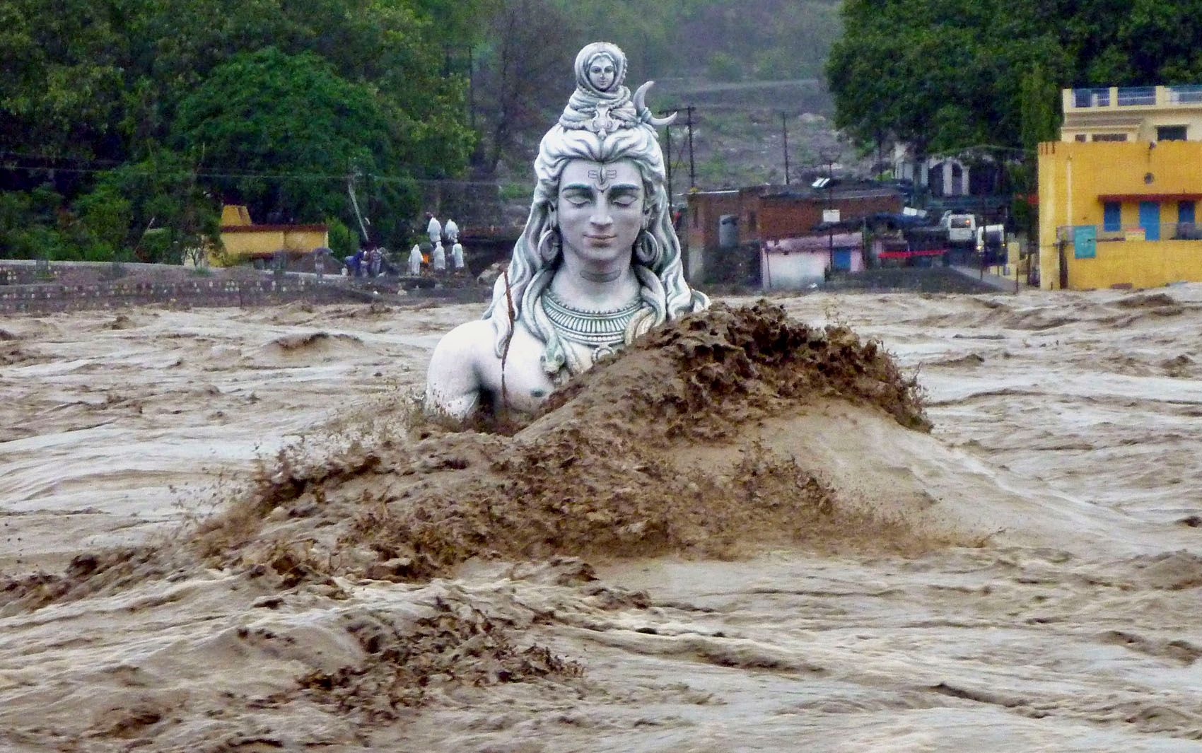 I find this statue of Shiva, nearly submerged in Indian floodwater, somehow very unsettling