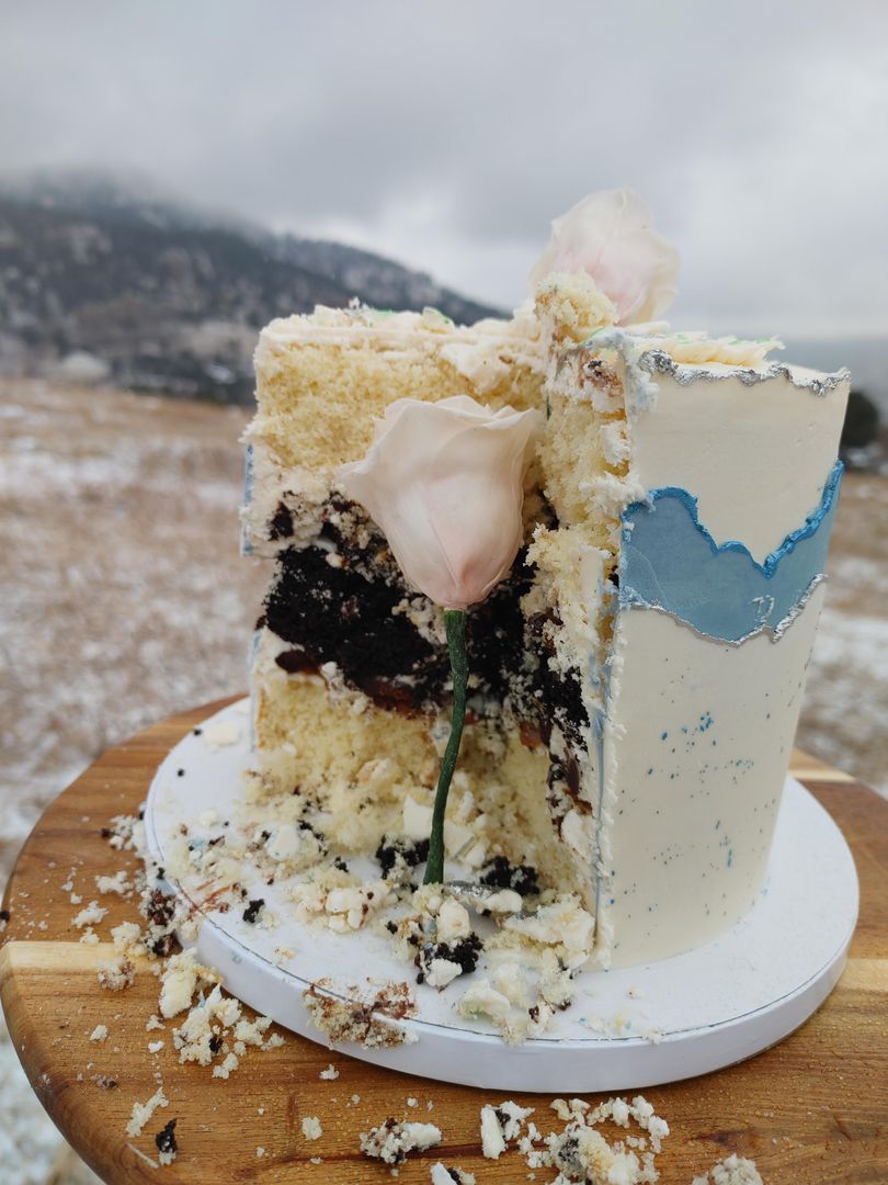 I made a Chocolate and vanilla layered cake with chocolate caramel crunch filling and fondant roses.