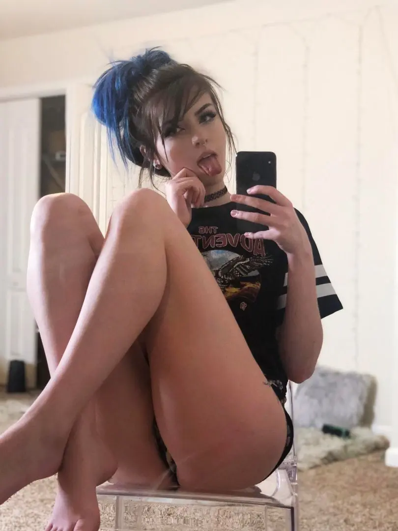 Curvy egirl with blue hair in a bun taking a mirror selfie, wearing a black graphic t-shirt and underwear