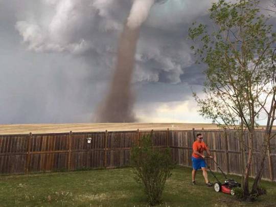 Man mows lawn during a tornado